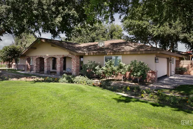 a view of a house with a yard and sitting area