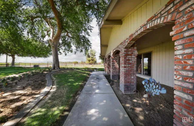 a view of a pathway with a wrought fence
