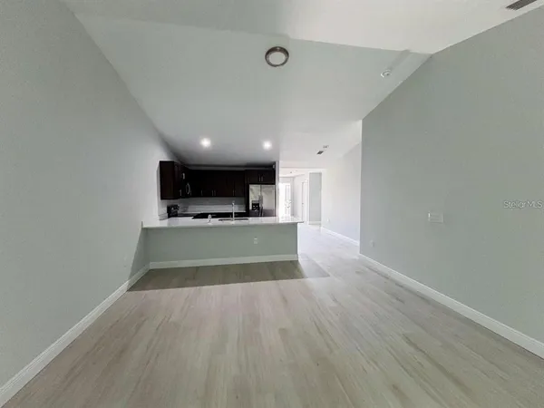 a view of kitchen with cabinets and wooden floor