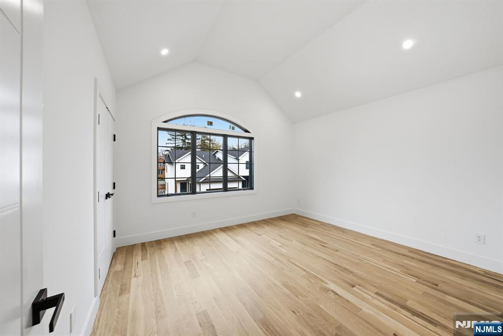 3 Cedar Court Demarest, NJ 07627 - Photo 33 of 49 an empty room with wooden floor chandelier and windows