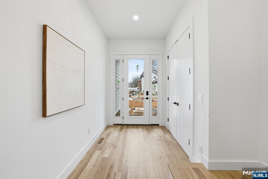 3 Cedar Court Demarest, NJ 07627 - Photo 4 of 49 a view of a hallway with wooden floor and a bathroom