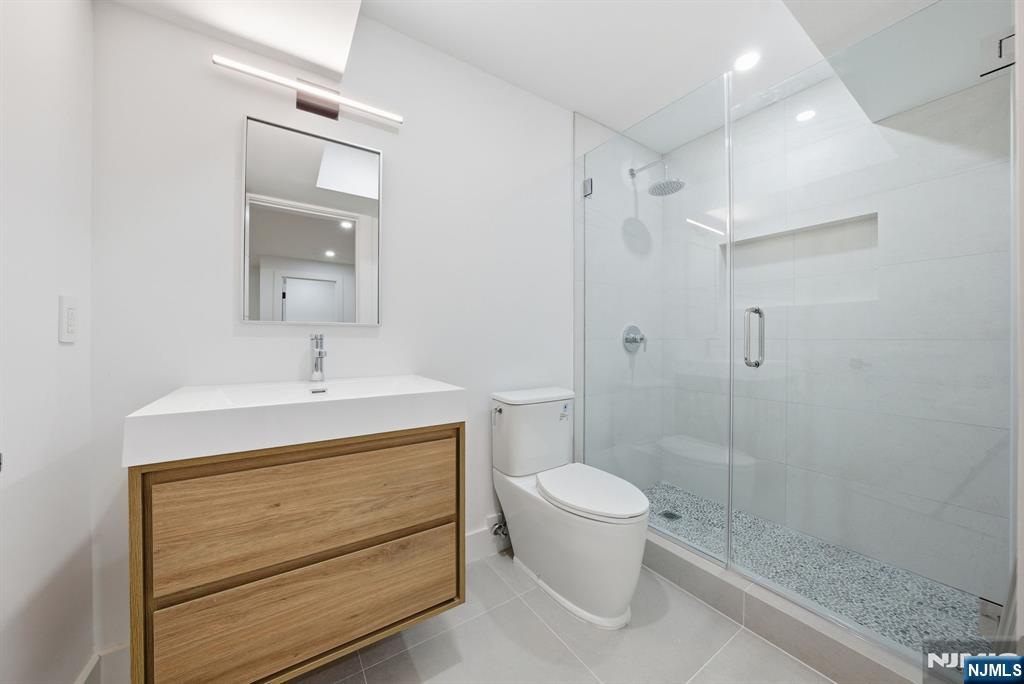 3 Cedar Court Demarest, NJ 07627 - Photo 42 of 49 a bathroom with a sink a toilet and shower