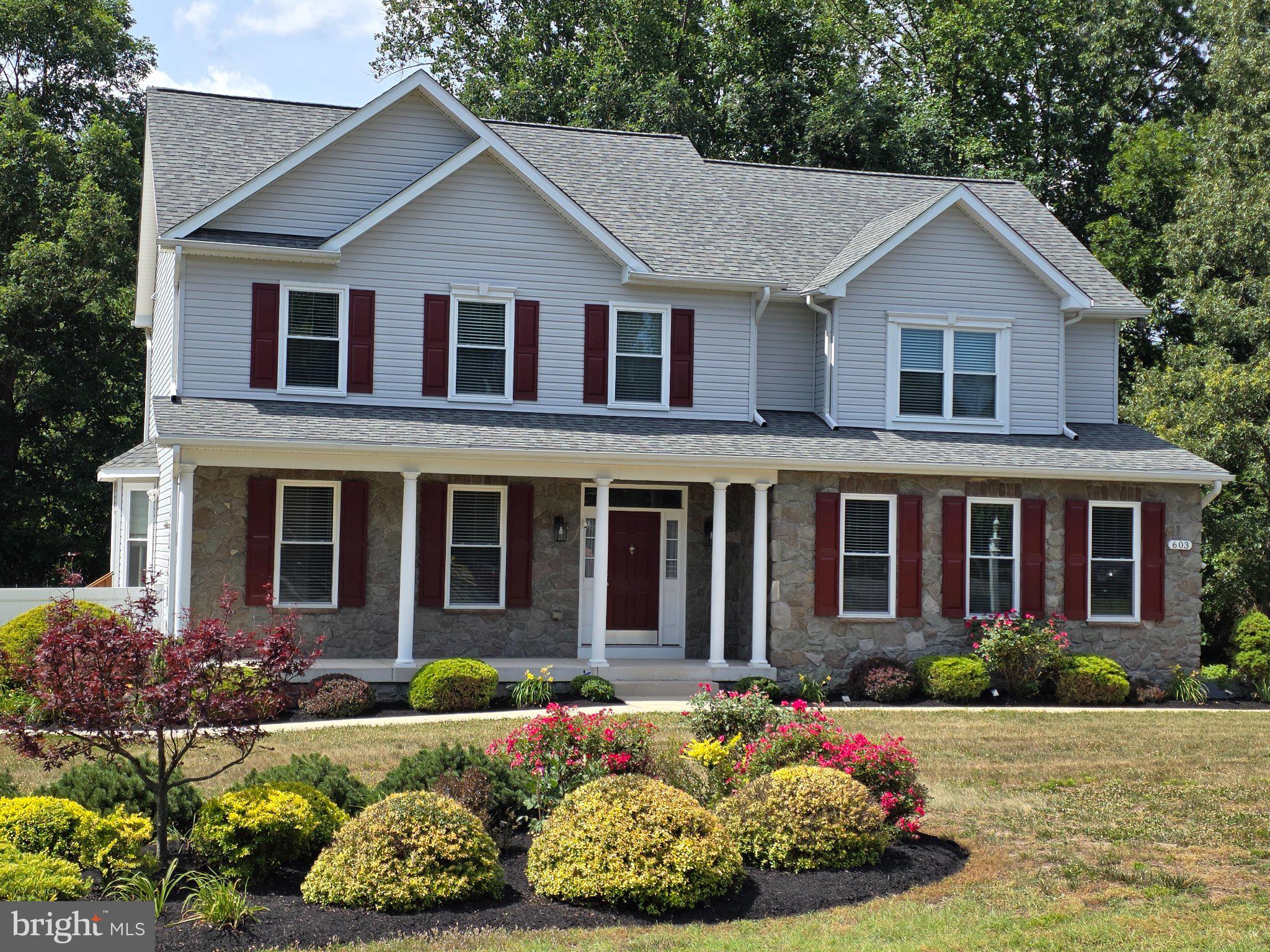 Charming home with vibrant landscaping.