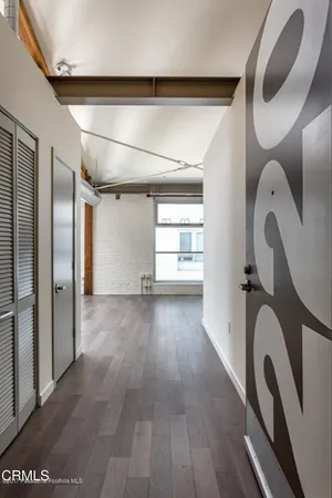 a view of a room with wooden floor