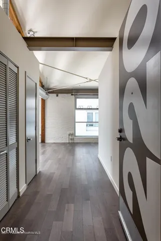 a view of a room with wooden floor