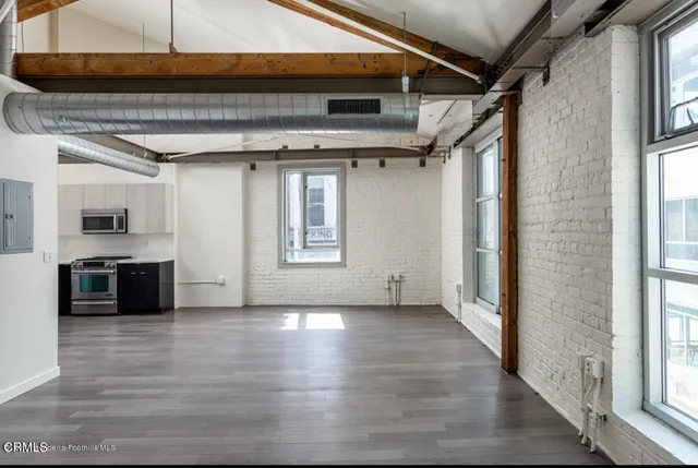 a view of a kitchen with a sink and a window