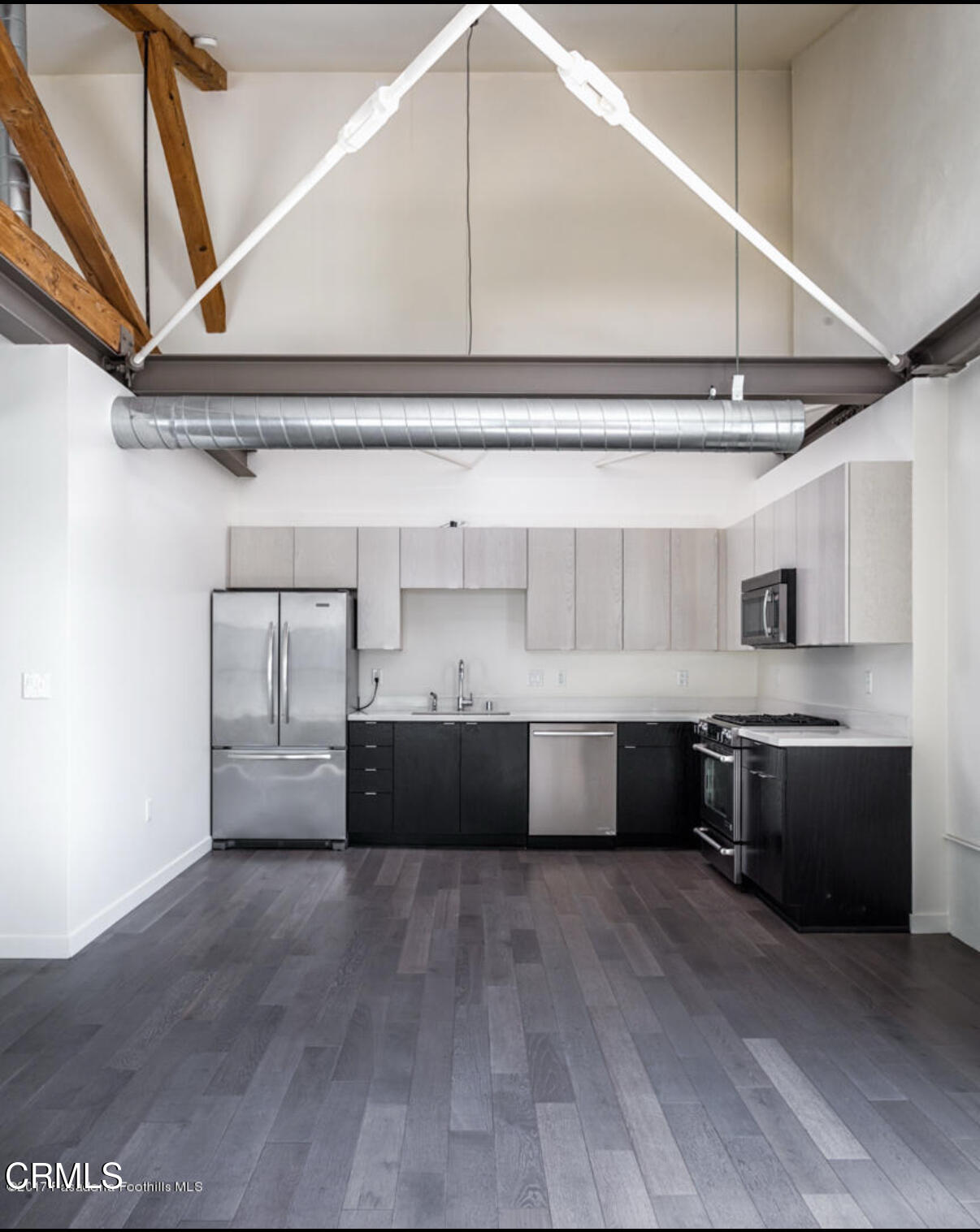 527 Molino Street, Unit 220 Los Angeles, CA 90013 - Photo 7 of 13 a living room with stainless steel appliances furniture and a kitchen view