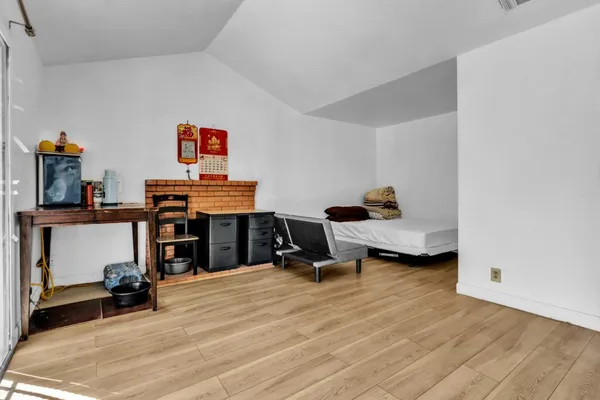 a bed room with a bed and a chair