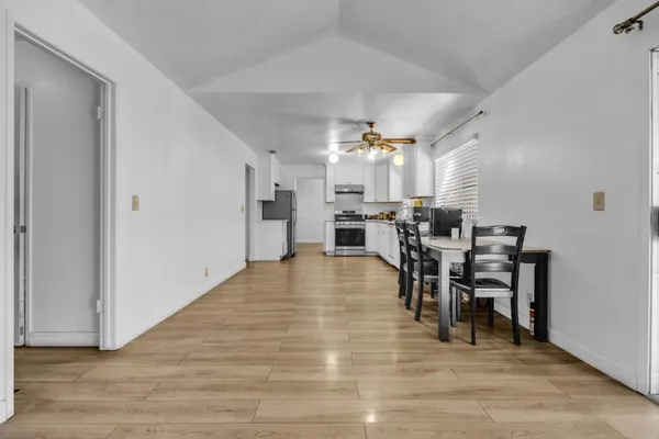 a view of a dining room with furniture and wooden floor