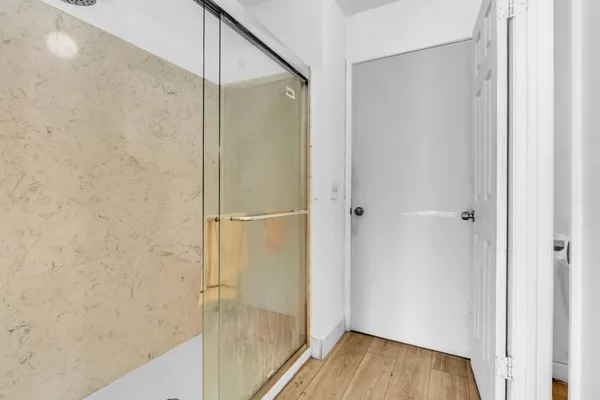 a bathroom with a glass shower door