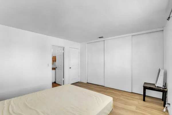 a bedroom with a bed and a chair