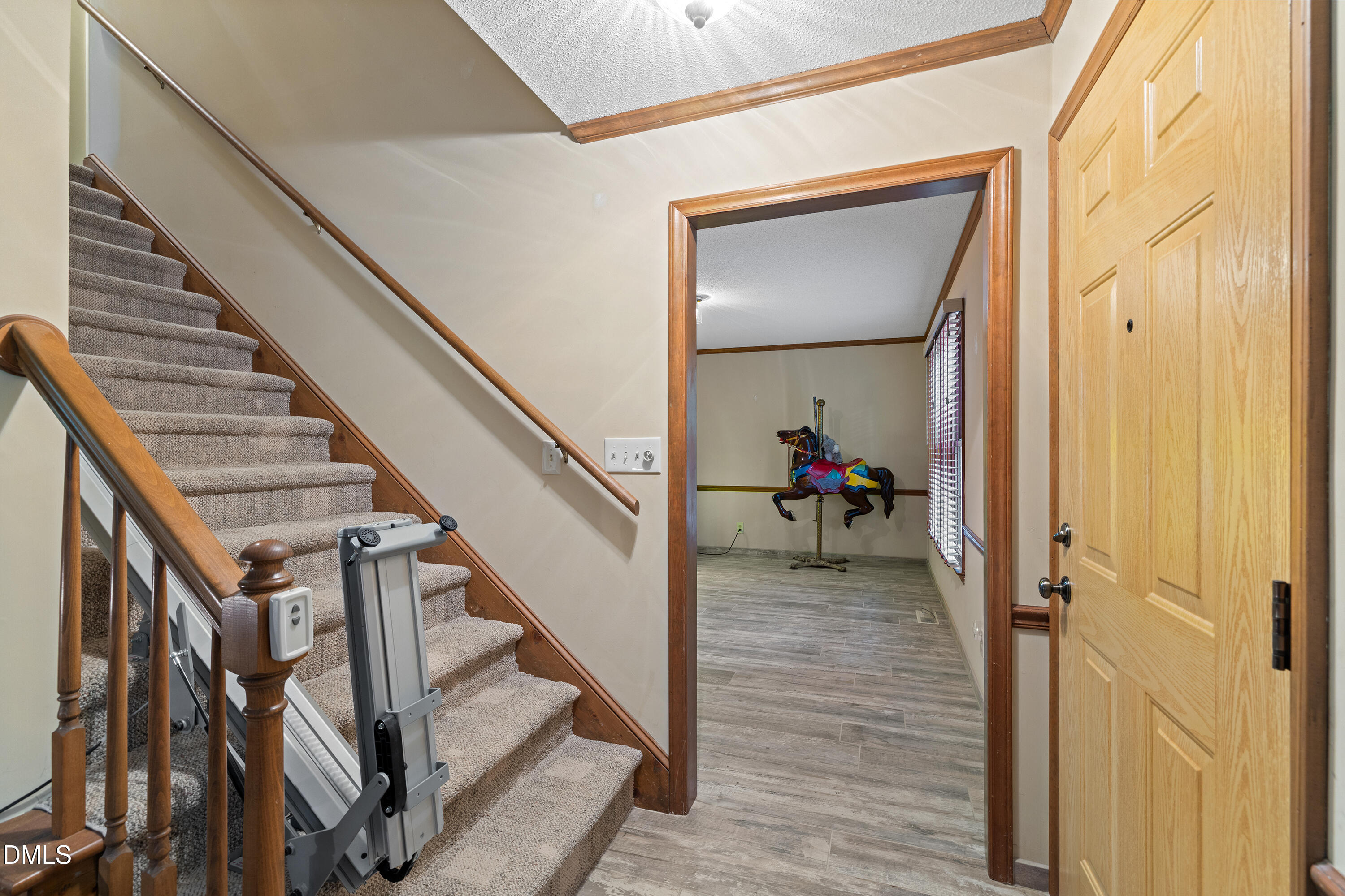 5216 Bridget Drive Raleigh, NC 27603 - Photo 11 of 30 a view of a hallway with wooden floor and stairs