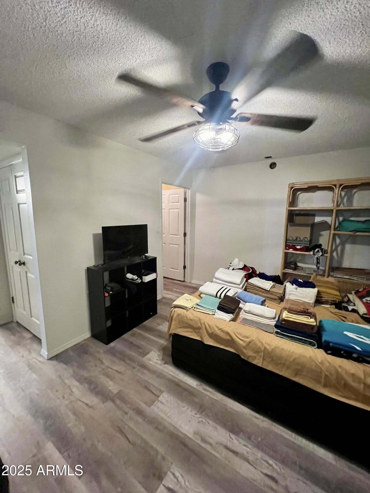 709 South Power Road, Unit 107 Mesa, AZ 85206 - Photo 17 of 26 a bedroom with a bed and a television