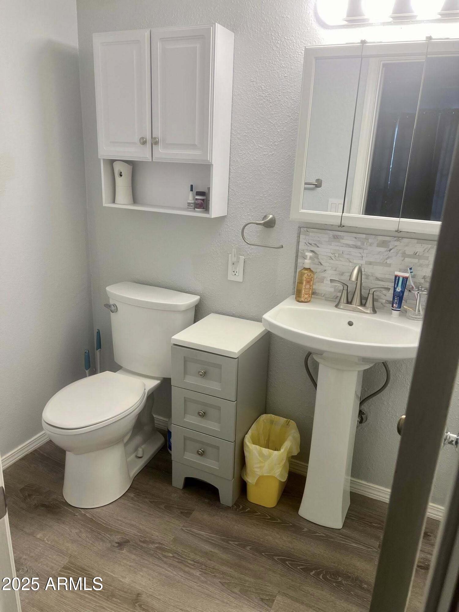 709 South Power Road, Unit 107 Mesa, AZ 85206 - Photo 19 of 26 a white toilet sitting next to a bathroom sink