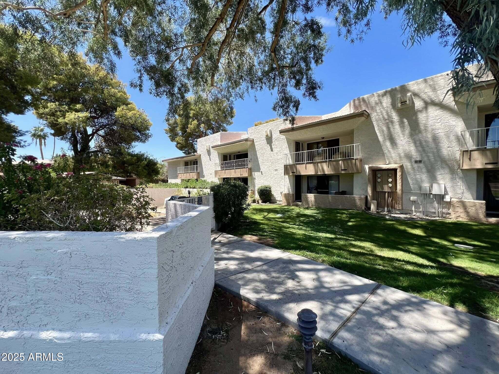 709 South Power Road, Unit 107 Mesa, AZ 85206 - Photo 2 of 26 a view of house with a yard
