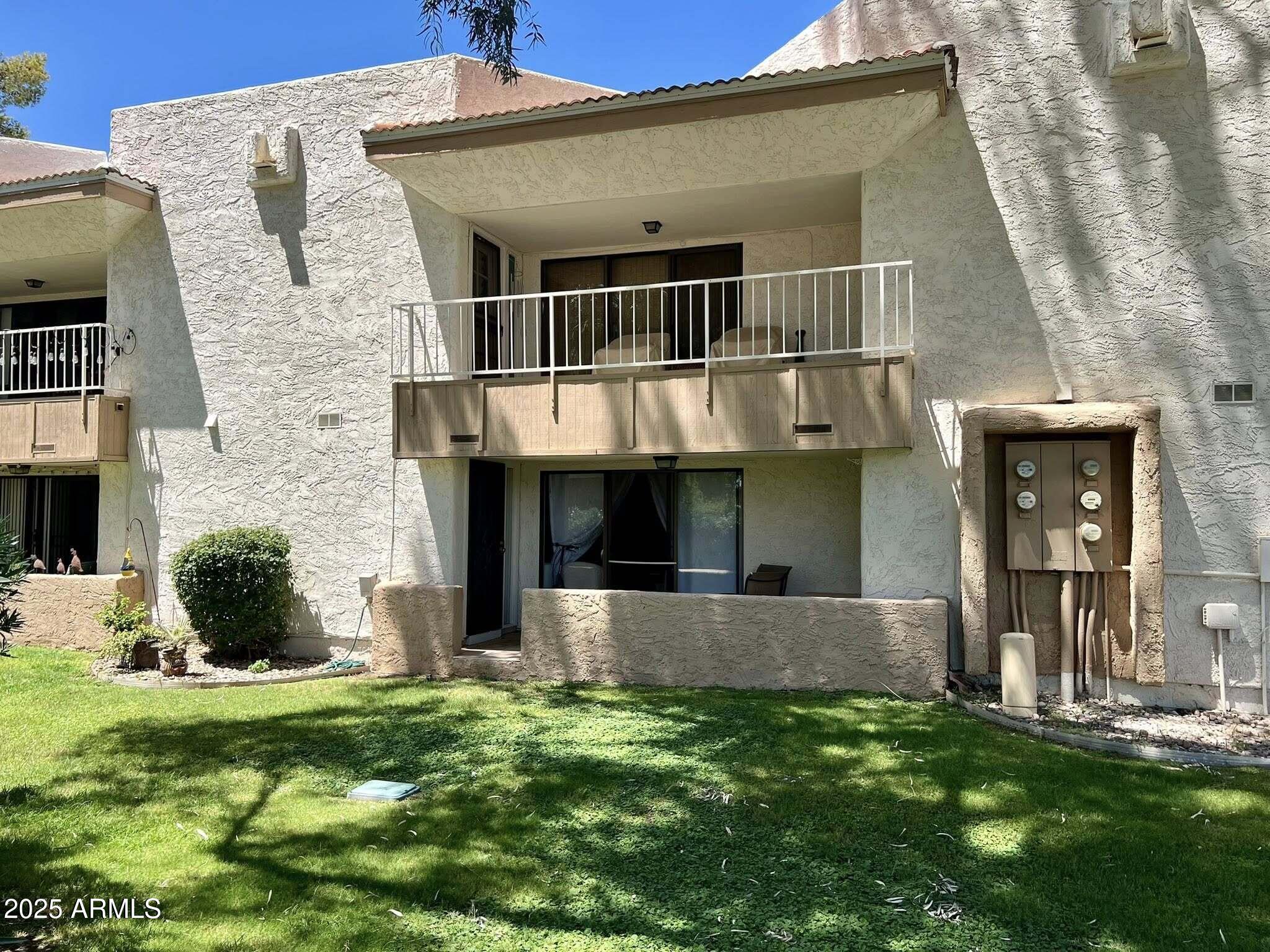 709 South Power Road, Unit 107 Mesa, AZ 85206 - Photo 7 of 26 a front view of a house with a yard