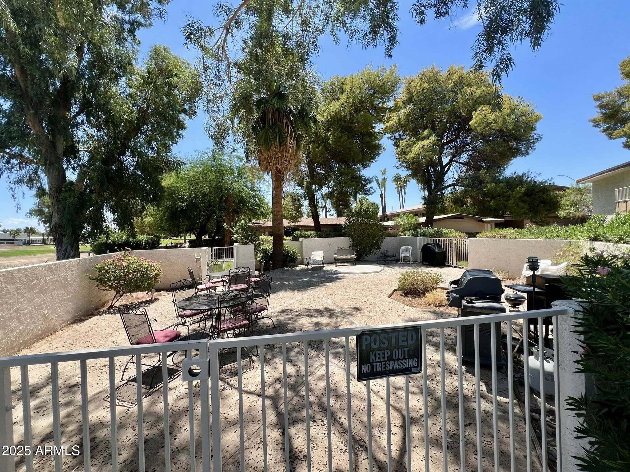709 South Power Road, Unit 107 Mesa, AZ 85206 - Photo 9 of 26 a view of a patio with chairs and a table
