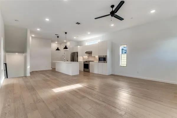 a view of a kitchen with a sink and a microwave