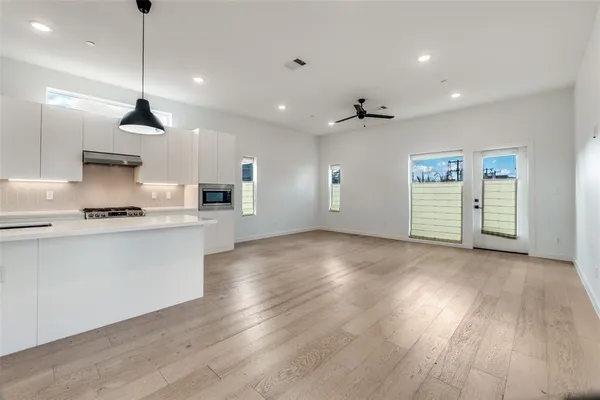 a view of a kitchen with a sink cabinets and wooden floor
