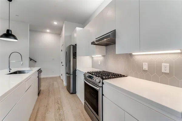 a kitchen with a sink a stove and refrigerator