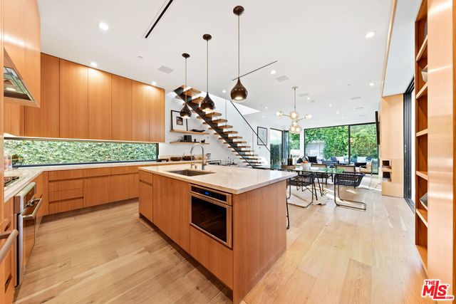 a kitchen with a stove and a wooden floor