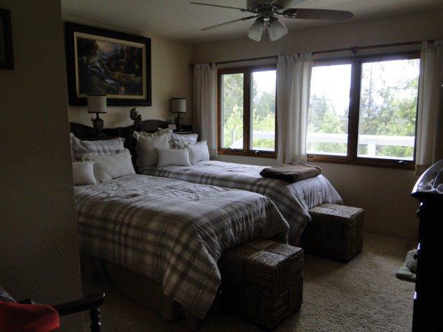 2000 Limpy Creek Road Grants Pass, OR 97527 - Photo 15 of 35 a bedroom with a bed and a chandelier