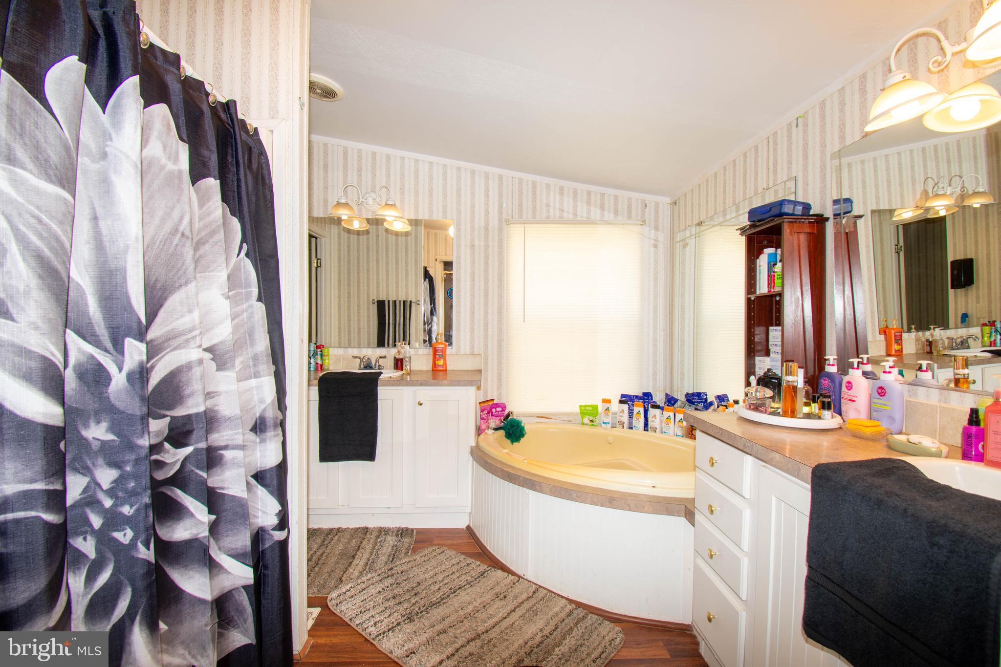 8791 Menokin Road Montross, VA 22520 - Photo 25 of 37 a bathroom with a bathtub sink and mirror