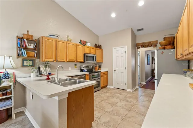 a kitchen with cabinets and appliances