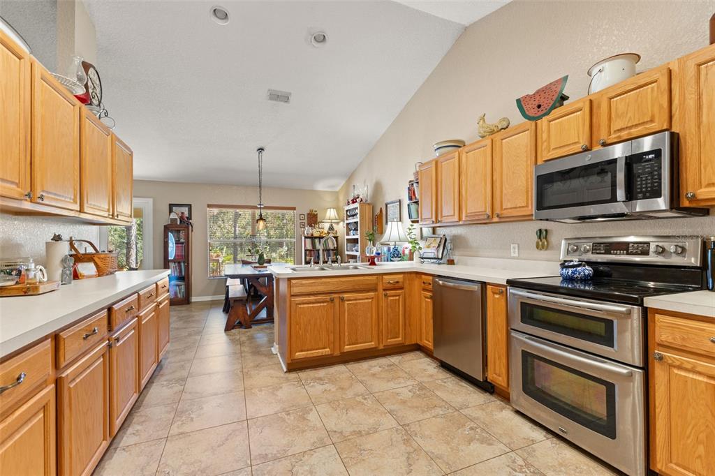 5 Boxleaf Court Homosassa, FL 34446 - Photo 19 of 58 a kitchen with stainless steel appliances granite countertop a stove top oven a sink dishwasher and white cabinets