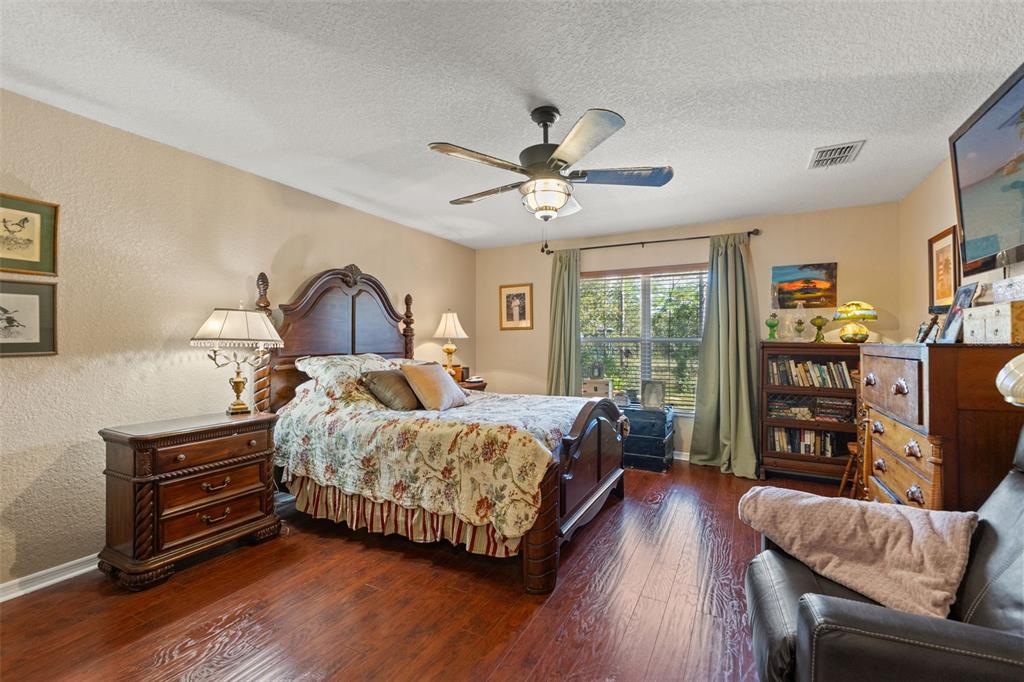 5 Boxleaf Court Homosassa, FL 34446 - Photo 21 of 58 a bedroom with a bed a couch and large window