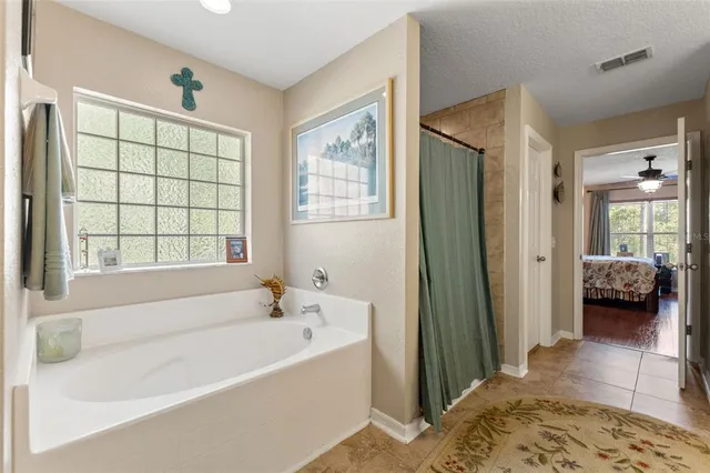 a bedroom with a bed bookshelf and a chair