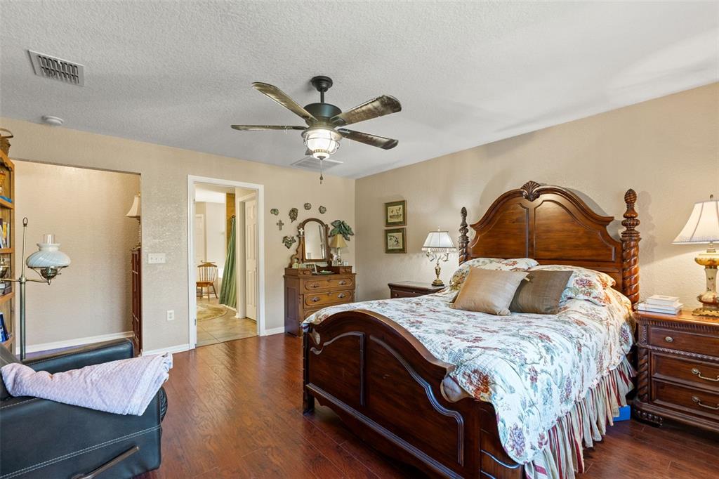 5 Boxleaf Court Homosassa, FL 34446 - Photo 31 of 58 a bedroom with a bed and wooden floor