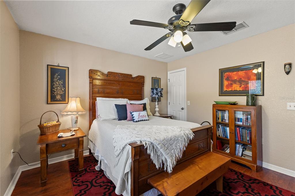 5 Boxleaf Court Homosassa, FL 34446 - Photo 33 of 58 a bedroom with a bed bookshelf and a chair