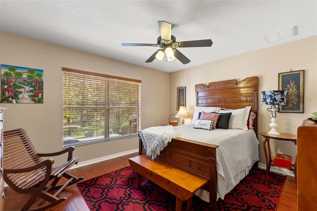 5 Boxleaf Court Homosassa, FL 34446 - Photo 37 of 58 a bedroom with a bed and wooden floor