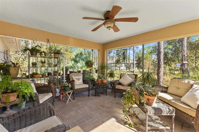 a living room filled with furniture and a large window