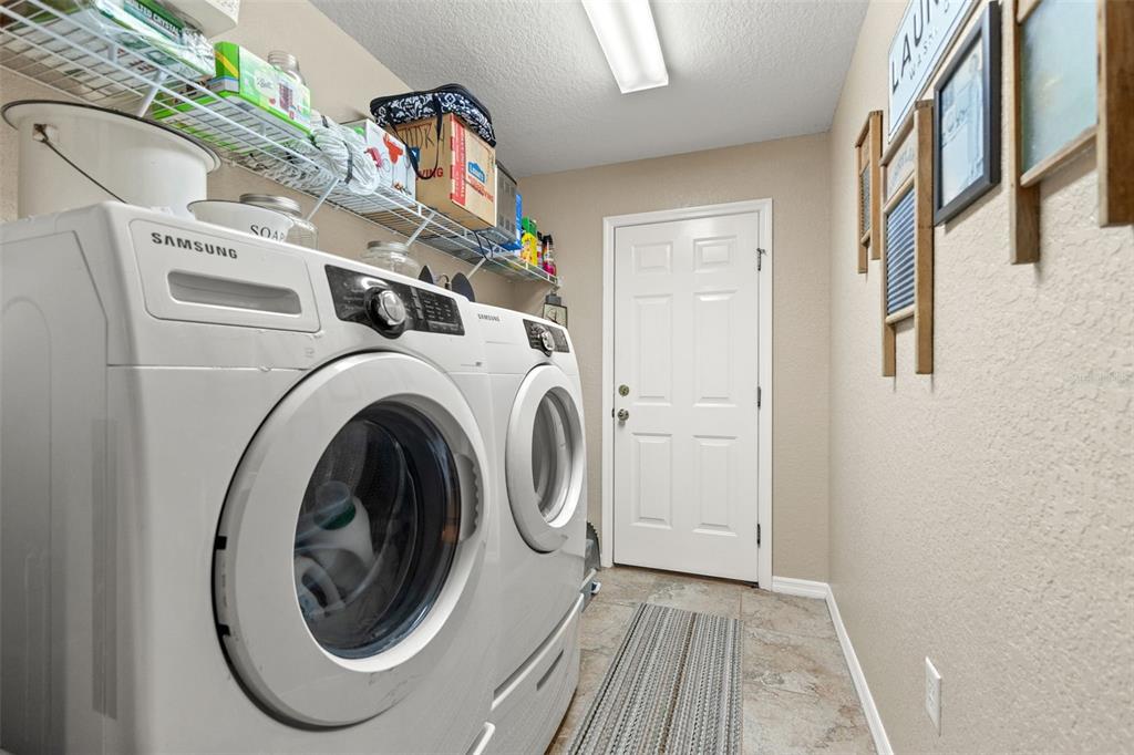 5 Boxleaf Court Homosassa, FL 34446 - Photo 43 of 58 a view of a storage & utility room with dryer and washer