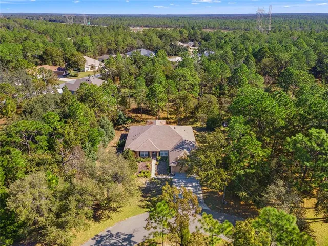 an aerial view of a houses with a yard