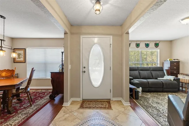 a room with a table chairs and a kitchen view