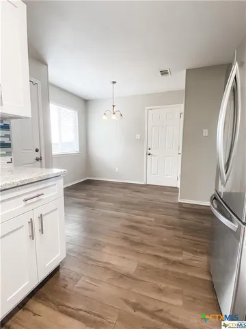a view of a kitchen from the hallway