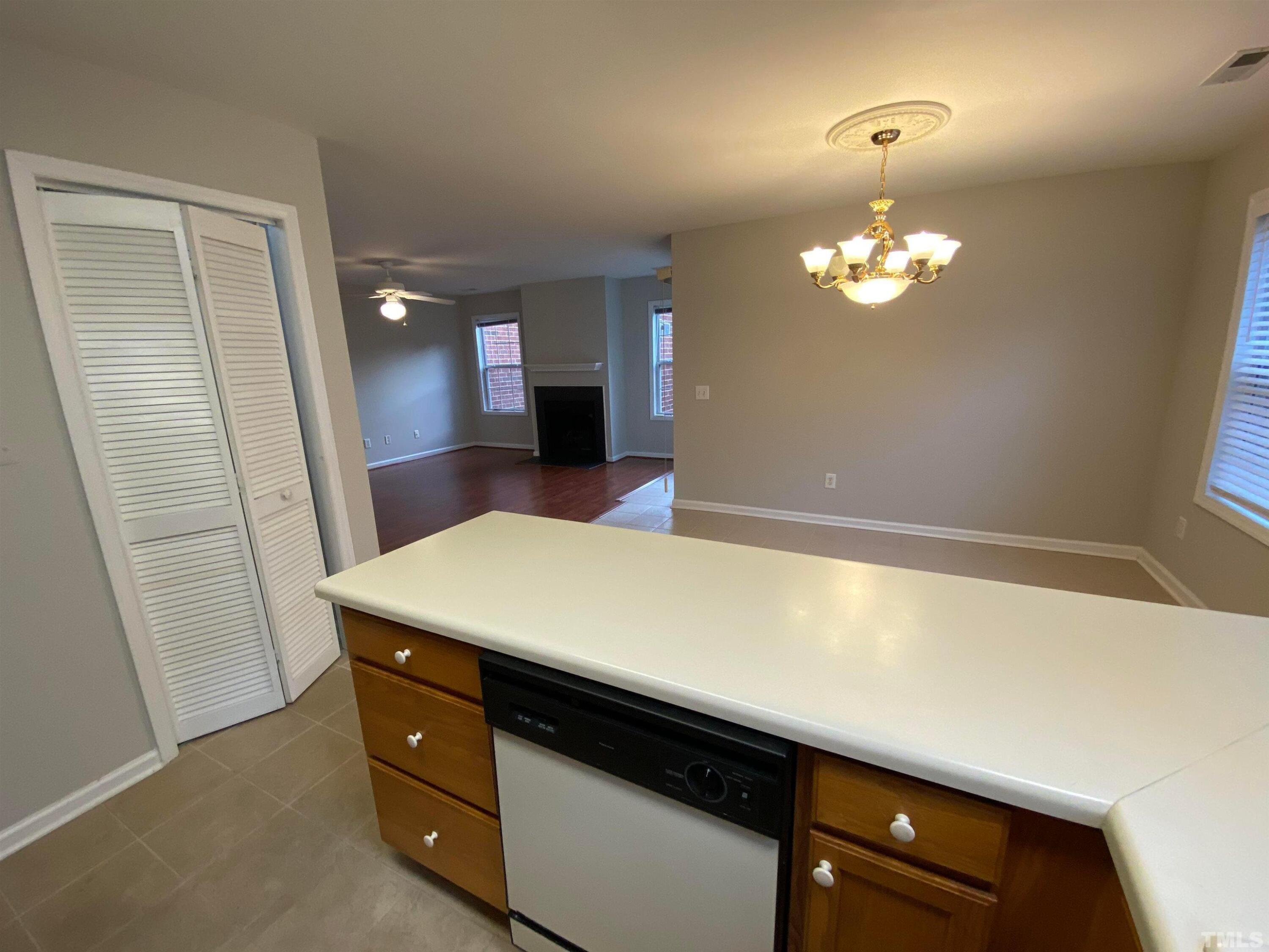 2413 Wellington Ridge Loop, Unit 2413 Cary, NC 27518 - Photo 15 of 30 a room with a chandelier furniture and wooden floor