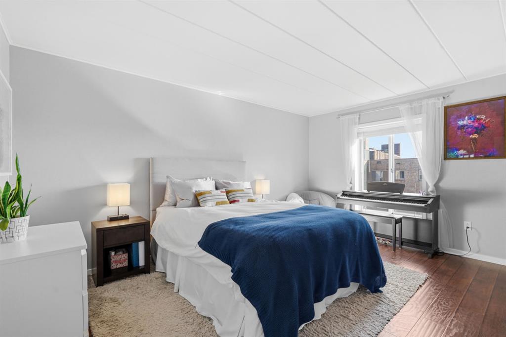 5 Bayard Road, Unit 810 Pittsburgh, PA 15213 - Photo 20 of 43 a bedroom with a bed and wooden floor