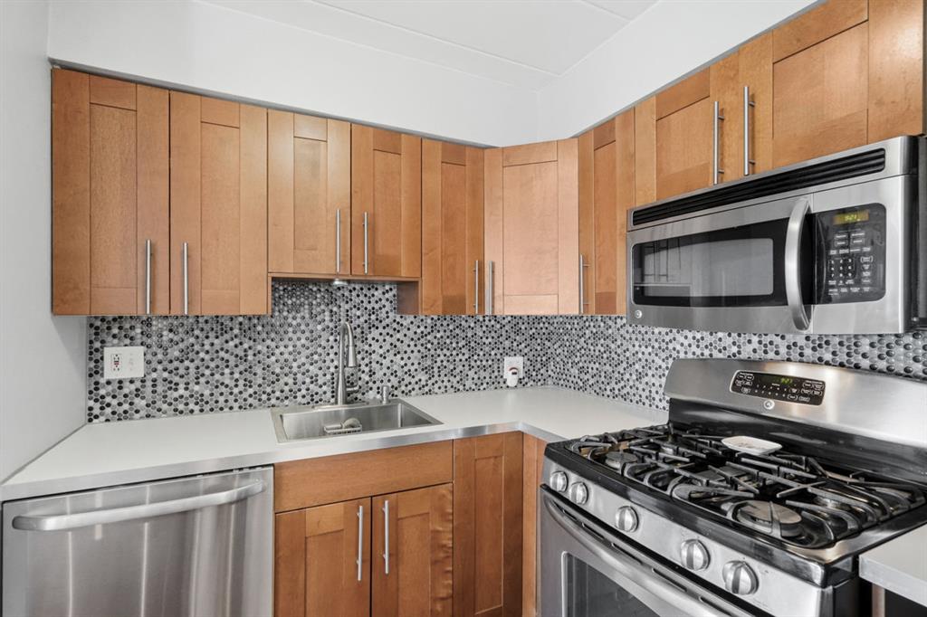 5 Bayard Road, Unit 810 Pittsburgh, PA 15213 - Photo 5 of 43 a kitchen with stainless steel appliances a stove a sink and a microwave