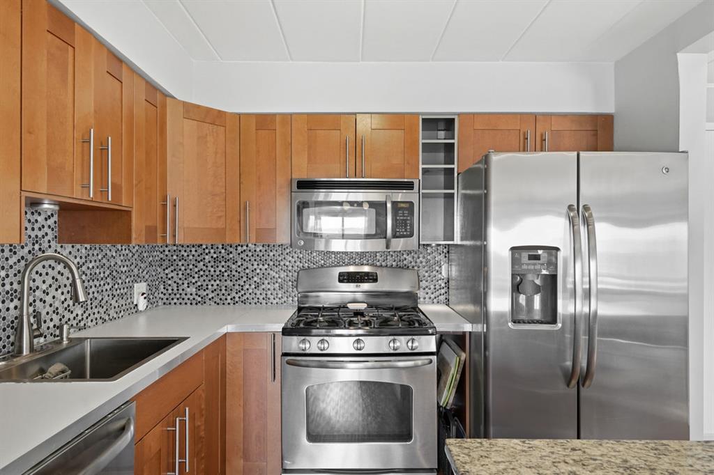 5 Bayard Road, Unit 810 Pittsburgh, PA 15213 - Photo 6 of 43 a kitchen with stainless steel appliances granite countertop a refrigerator a sink and a stove