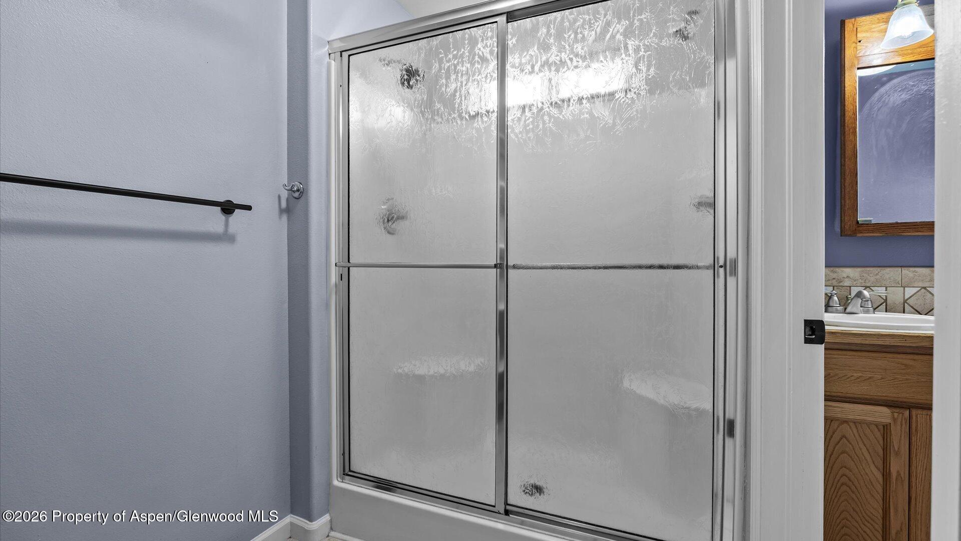 1459 Anvil View Avenue Rifle, CO 81650 - Photo 16 of 29 a bathroom with a glass shower door