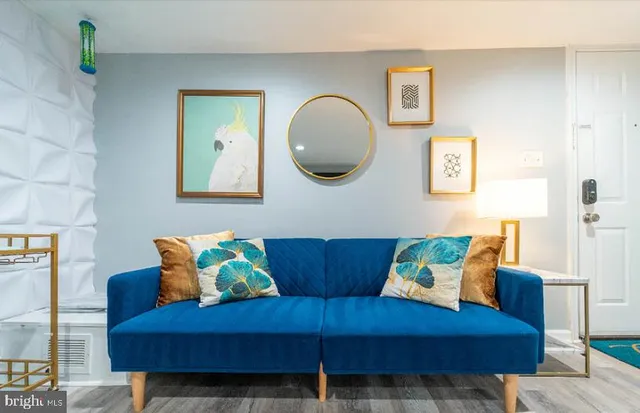 a living room with furniture and a mirror