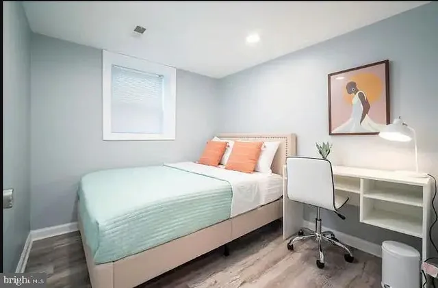 a bedroom with a bed and a desk