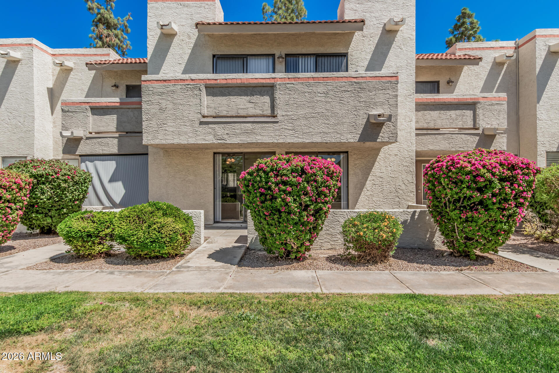 985 North Granite Reef Road, Unit 129 Scottsdale, AZ 85257 - Photo 1 of 38 a front view of a house with garden