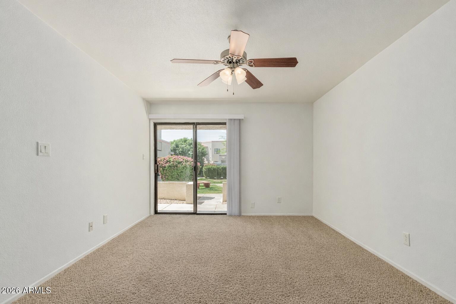 985 North Granite Reef Road, Unit 129 Scottsdale, AZ 85257 - Photo 12 of 38 an empty room with windows and ceiling fan