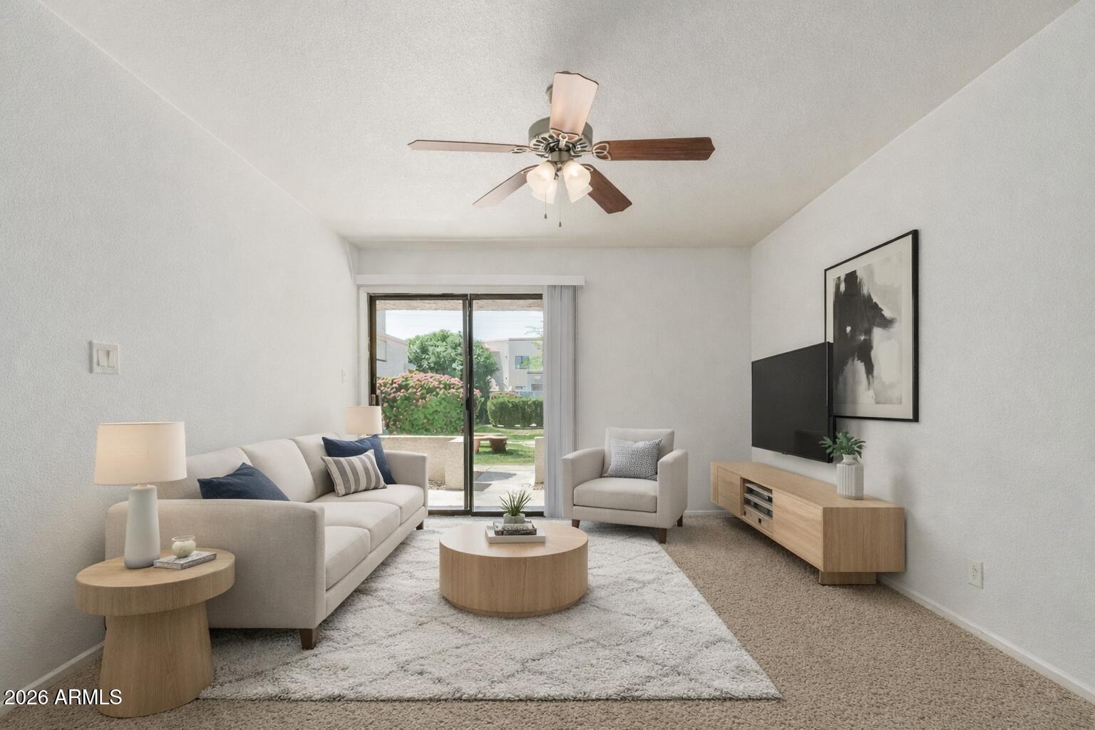 985 North Granite Reef Road, Unit 129 Scottsdale, AZ 85257 - Photo 13 of 38 a living room with furniture and a flat screen tv