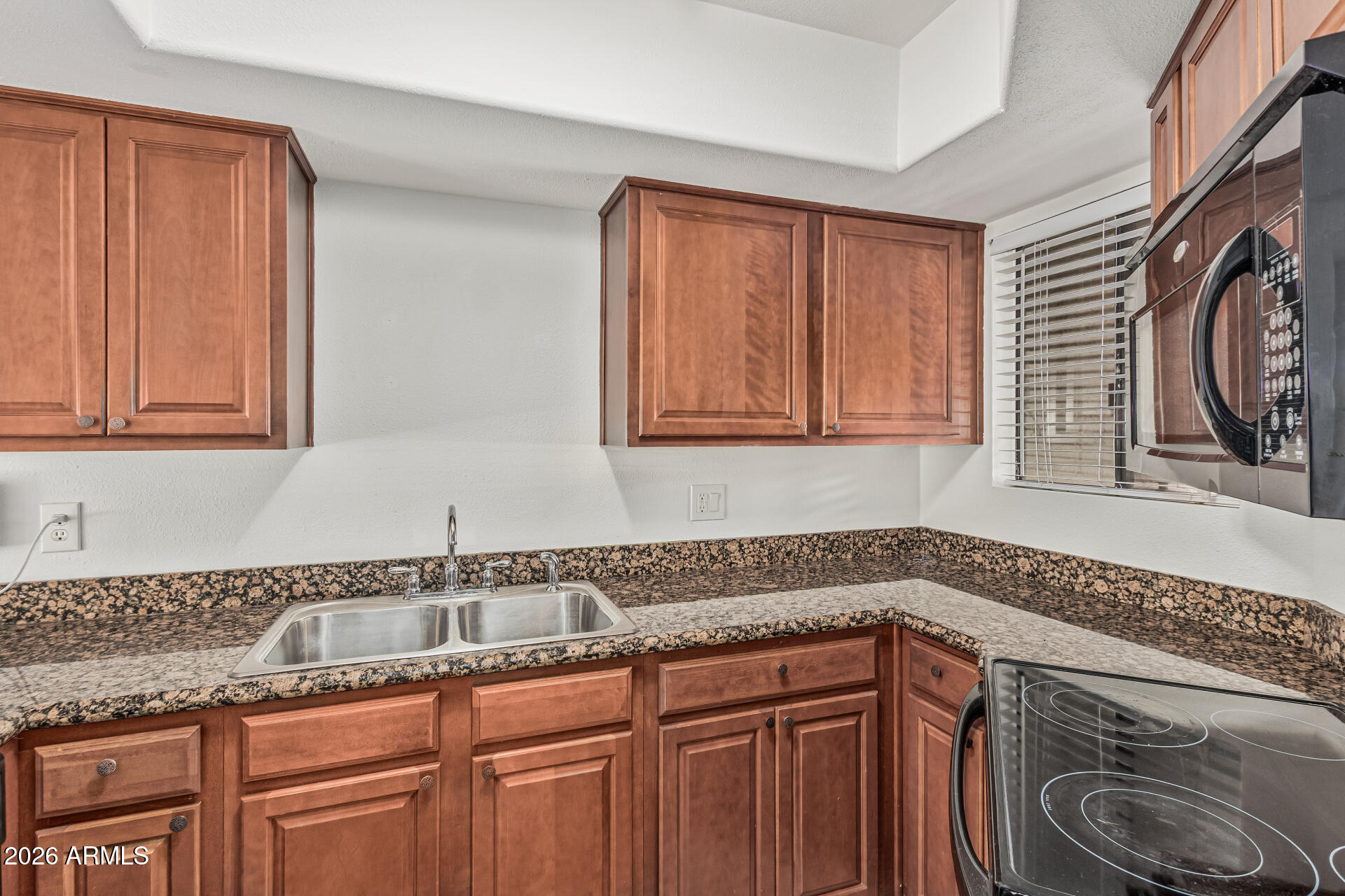 985 North Granite Reef Road, Unit 129 Scottsdale, AZ 85257 - Photo 17 of 38 a kitchen with a sink and cabinets
